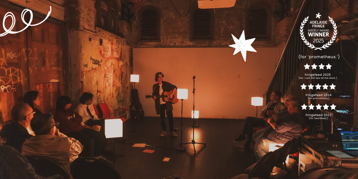 a person with short brown hair stands towards the back of a stage, playing the guitar. they are surrounded by audience members. multiple square lights, standing at different heights, are placed across the stage, and a mic stands in the centre. over the right side of the image is a list of accolades from previous shows: a weekly award laurel from adelaide fringe, two five star reviews and one four star review from fringefeed.