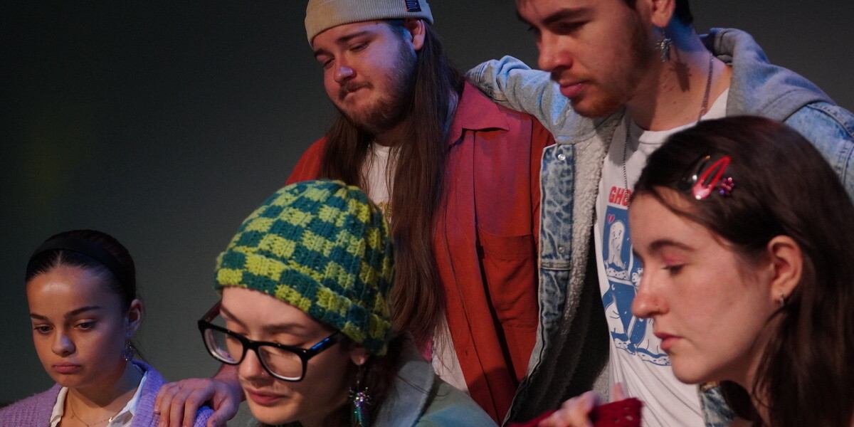 Five actors looking downwards.