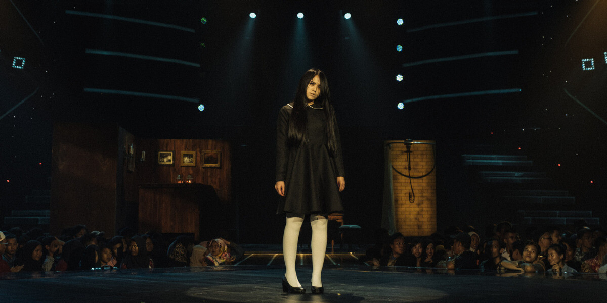 Sacred Riana stares intensely on stage