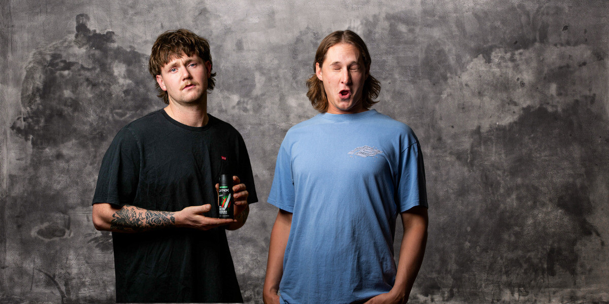 Blazed and Confused: Mitch Glenn, Wyatt Nixon and co.–Promotional poster for Blazed and Confused, a stoner comedy show presented by Grassroots Comedy. The image features comedians Mitch Glenn and Wyatt Nixon in a fisheye-lens shot inside a suburban patio, holding a bong and a drink can with a messy coffee table behind them. Bold retro red-and-white text reads “Blazed and Confused.”