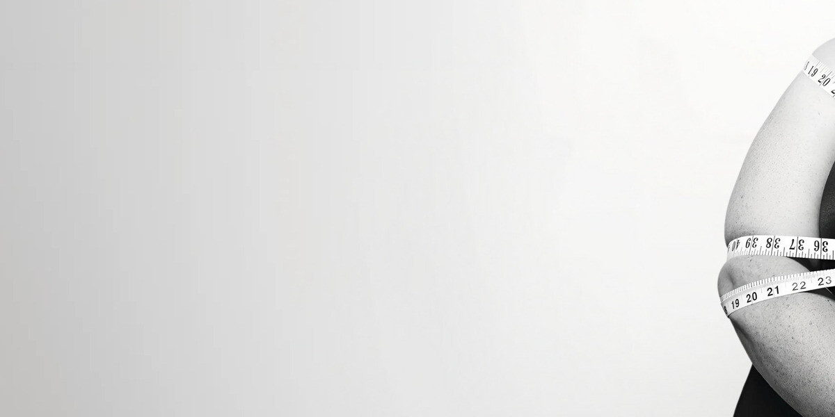 Woman tied up with tape measures in black and white