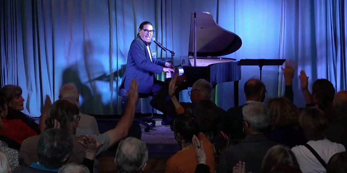 DrH sitting at a piano