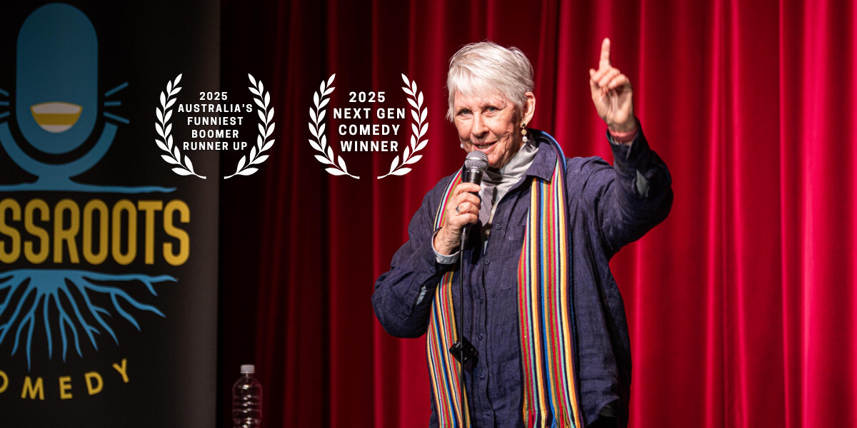 Nola Bliss performs on stage in front of red curtains, holding a microphone and raising one hand. To the left is a Grassroots Comedy banner. Text reads: “The silver-haired grandmother, Nola Bliss, exuded cougar confidence… had the audience in side-splitting R-rated laughter – FringeFeed.” A laurel badge below says “2025 Australia’s Funniest Boomer Runner Up.” To the right, additional text reads: “I drove 2 hours in from York to do this show… – Nola Bliss.”