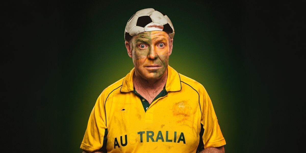 Pete Helliar - An International Kerfuffle–Comedian Pete Helliar wears a yellow sports jersey with 'AUSTRALIA' partially visible on the front. His face is painted green and gold, and he has a soccer ball hat on his head. The background features a gradient from dark green to light green.