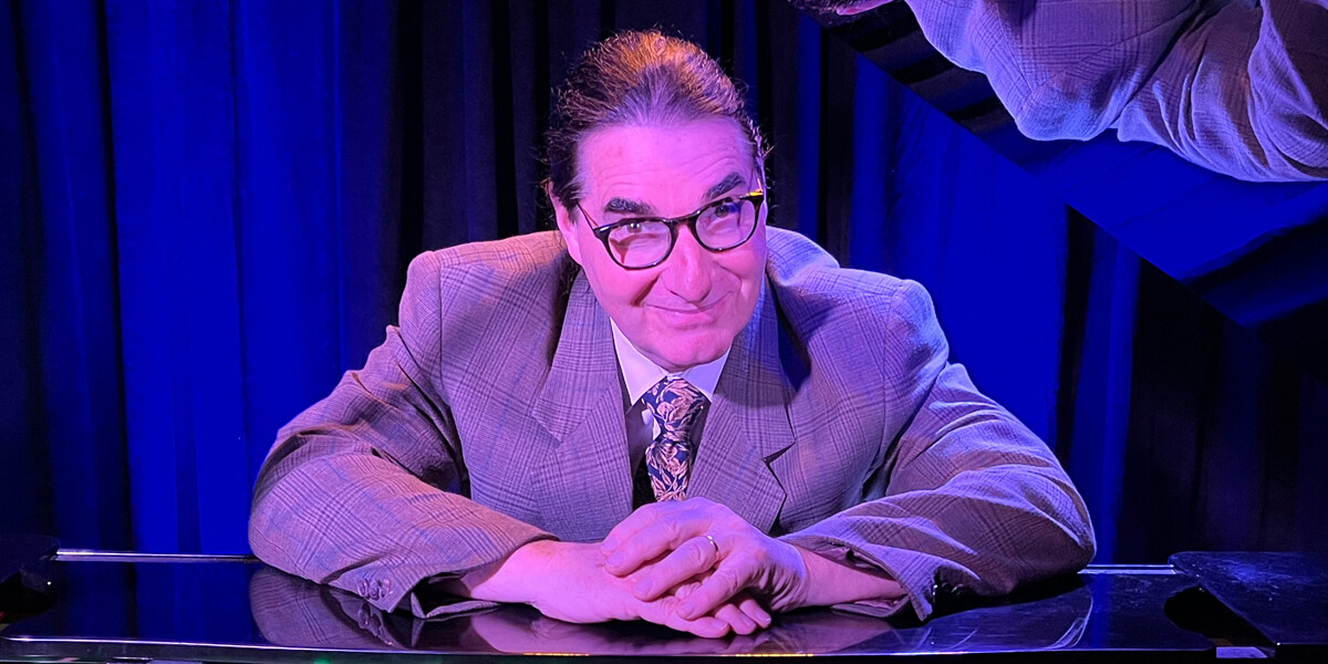 An Unwasted Evening - The Genius of Tom Lehrer–DrH sitting at a piano