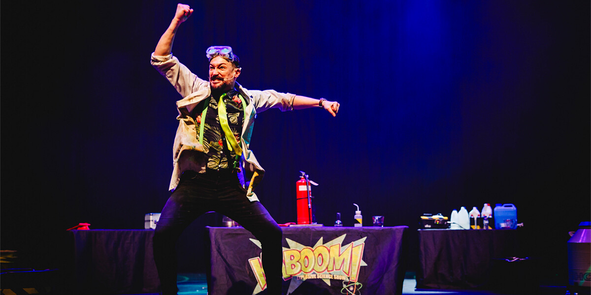 Live picture from show, performer leaping in mid-air celebrating.