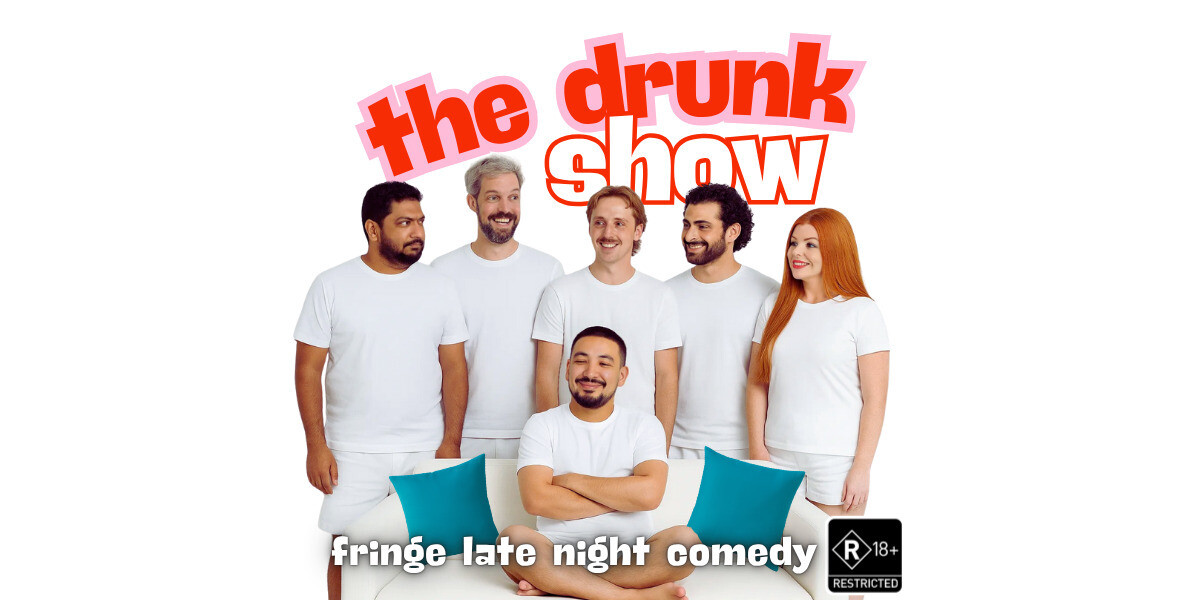 The Drunk Show: Comedy up Late–Six comedians dressed in matching white T-shirts and shorts stand behind a white couch, smiling and looking at each other. One performer sits cross-legged on the couch with arms folded, smiling confidently. Two teal cushions rest on either side of him. Above the group, bold red and pink text reads “the drunk show.”