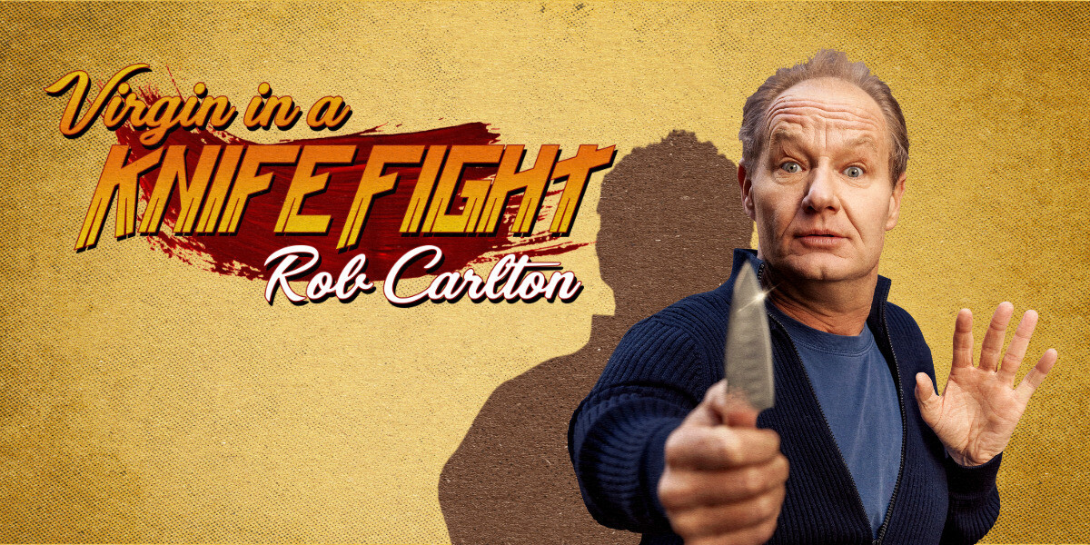 VIRGIN IN A KNIFE FIGHT–“Rob Carlton holding a knife with a surprised look against a yellow background — humorous and theatrical.”