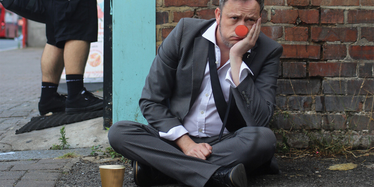 Paul Savage: Comic, Relieved–Paul Savage, sat in a suit with a charity tin, on the floor of a high st. He is bedraggled and looks sad. You still would, though. You're only human