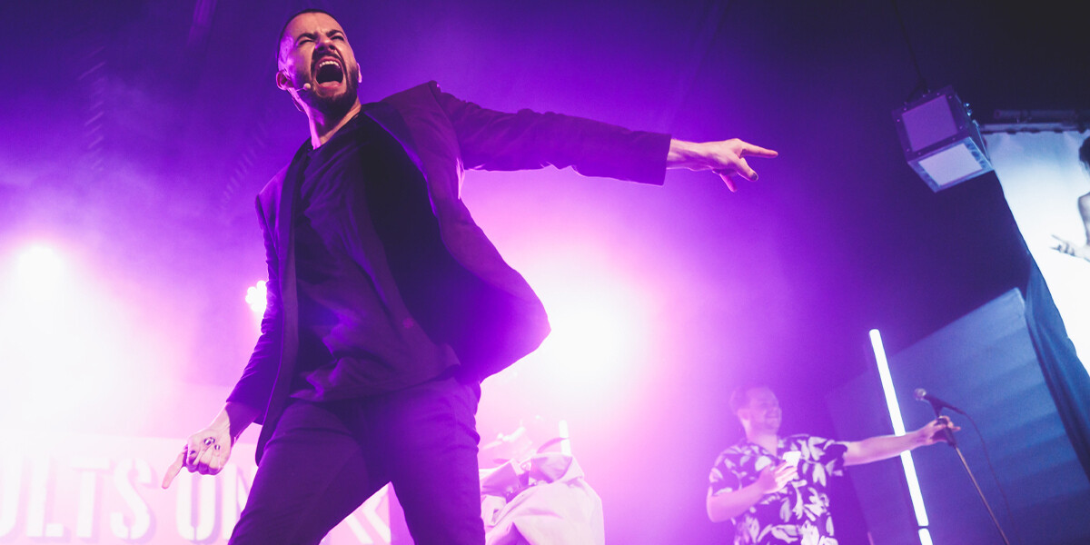 Oen magician pointing to his left with an exclamation on his face signalling energy and victory.